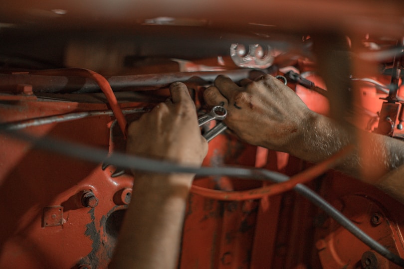 Mechanic repairing agricultural equipment