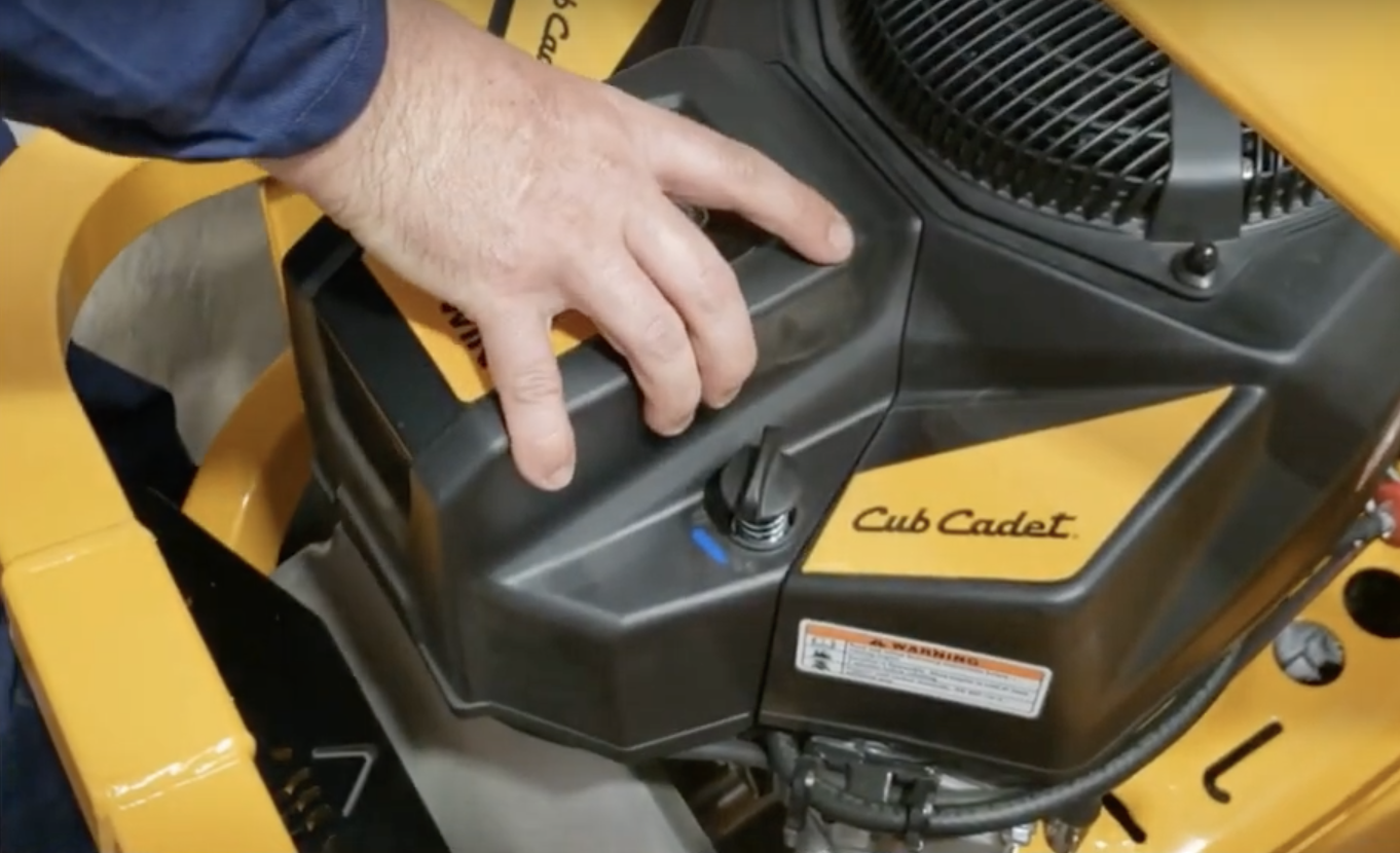 Mechanic servicing a Cub Cadet mower engine
